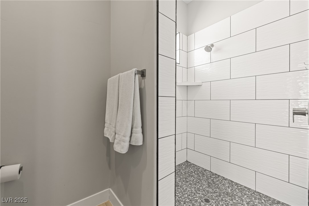 1357 Manassas Ridge Mesquite, NV 89027 - Photo 21 of 72 Bathroom with a tile shower and baseboards