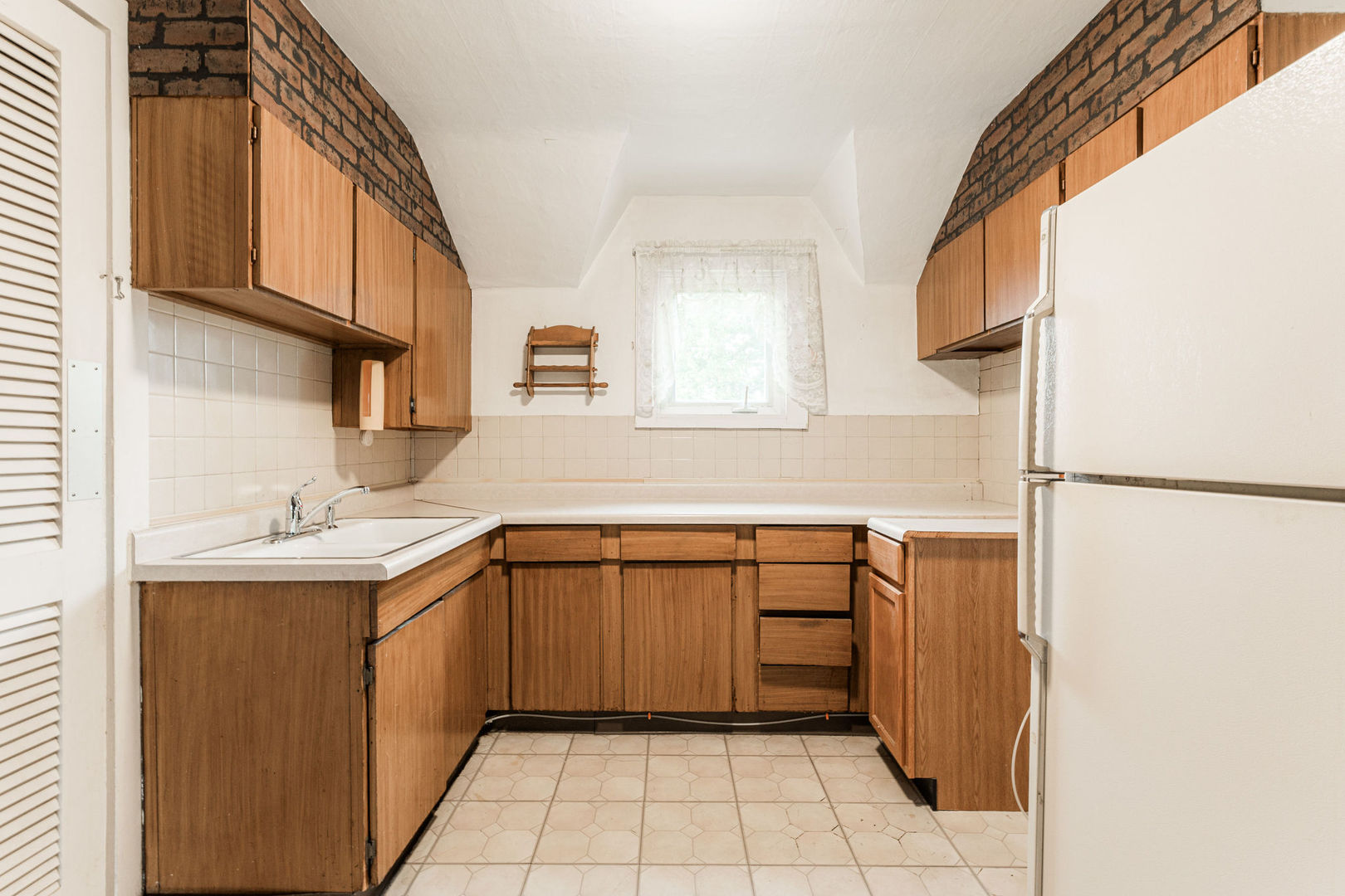 3877 Rich Road Malta, IL 60150 - Photo 25 of 43 a kitchen with a sink a refrigerator and cabinets