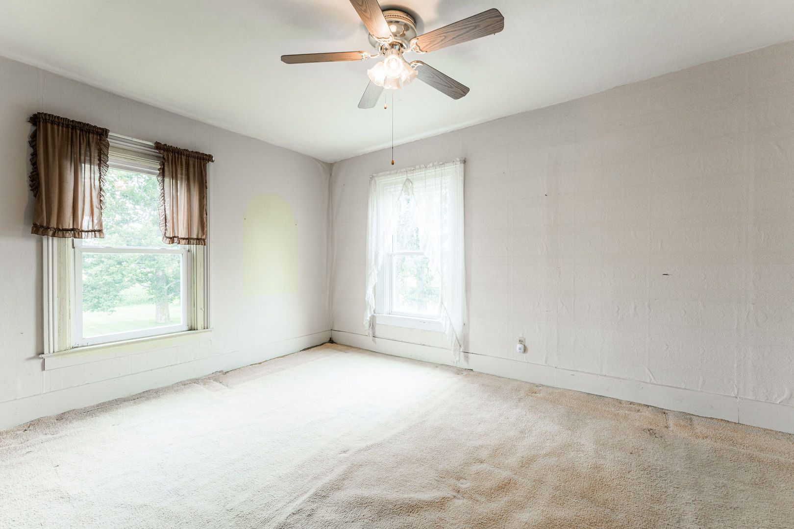 3877 Rich Road Malta, IL 60150 - Photo 27 of 43 an empty room with chandelier fan and windows