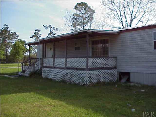 1731 Jacks Branch Road Cantonment, FL 32533 - Photo 2 of 2 a front view of a house with a garden