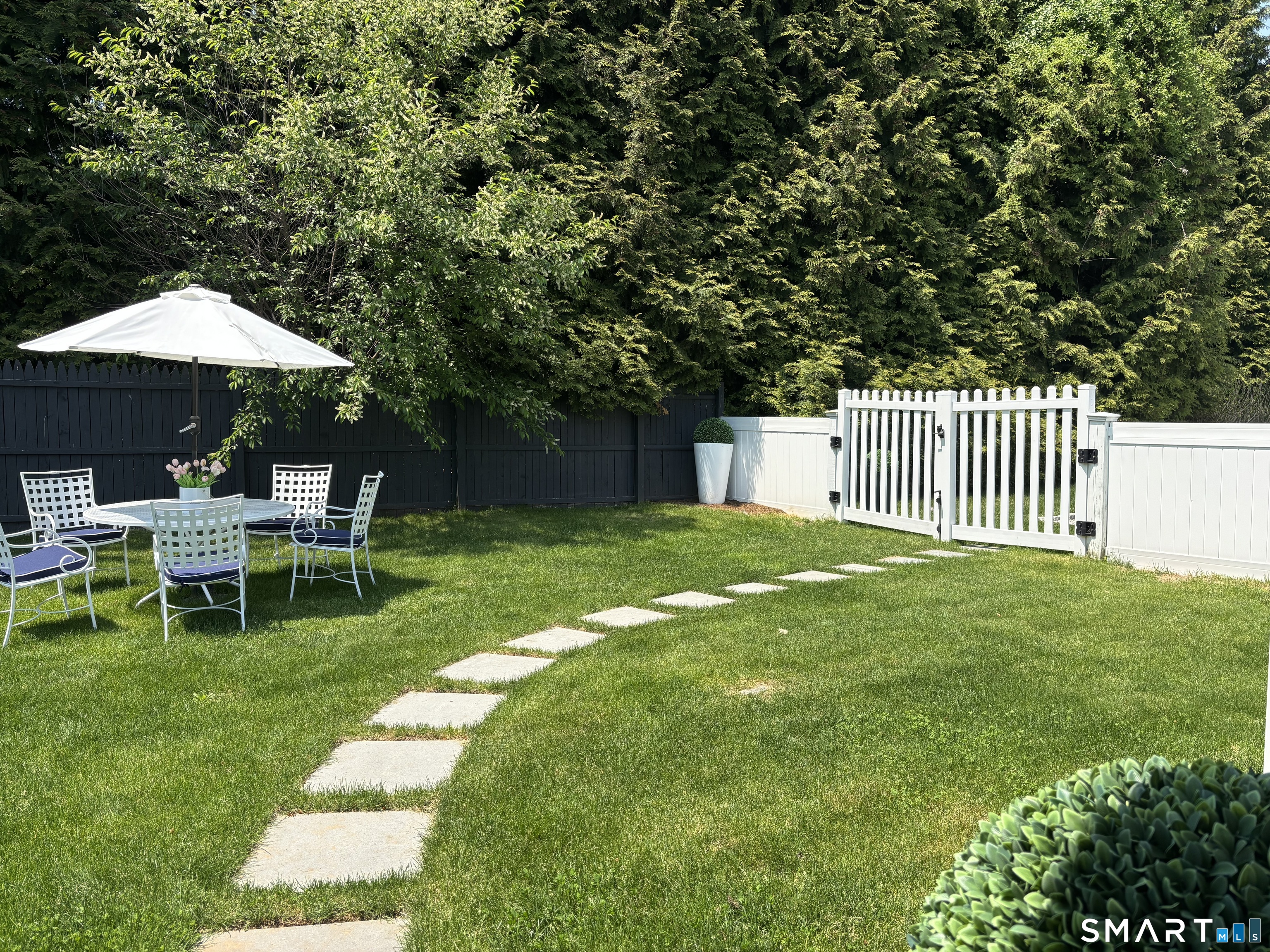 4 A Stoneboat Road Westport, CT 06880 - Photo 4 of 24 a view of a chair and table in the garden