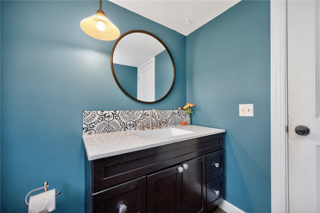 4747 Fawnwood Road Dayton, OH 45429 - Photo 22 of 58 This bathroom features a sleek vanity, patterned tile backsplash, and elegant mirror.
