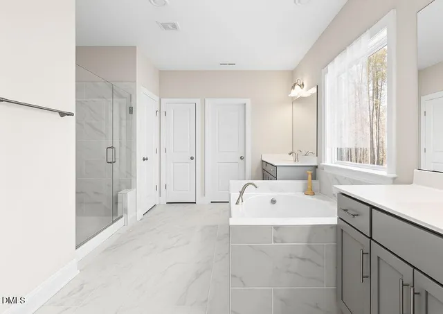 a bedroom with a bed lamp and window