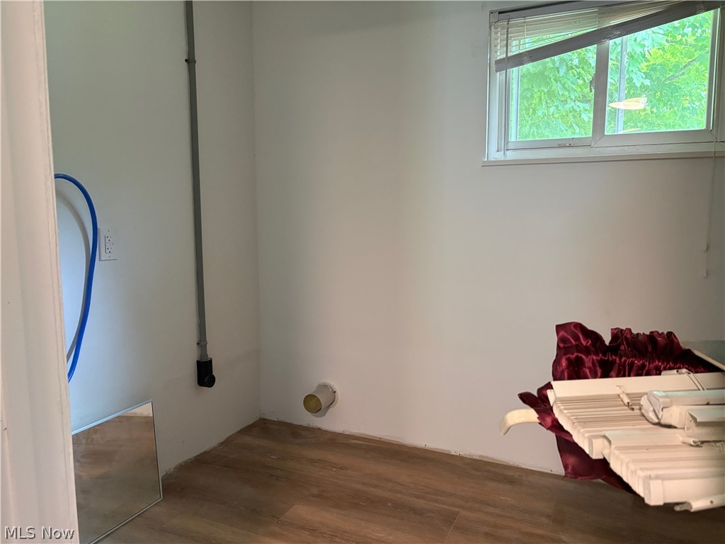 1448 Winding Road Parkersburg, WV 26104 - Photo 3 of 12 Room with wood-finish flooring, white walls, and a window with blinds