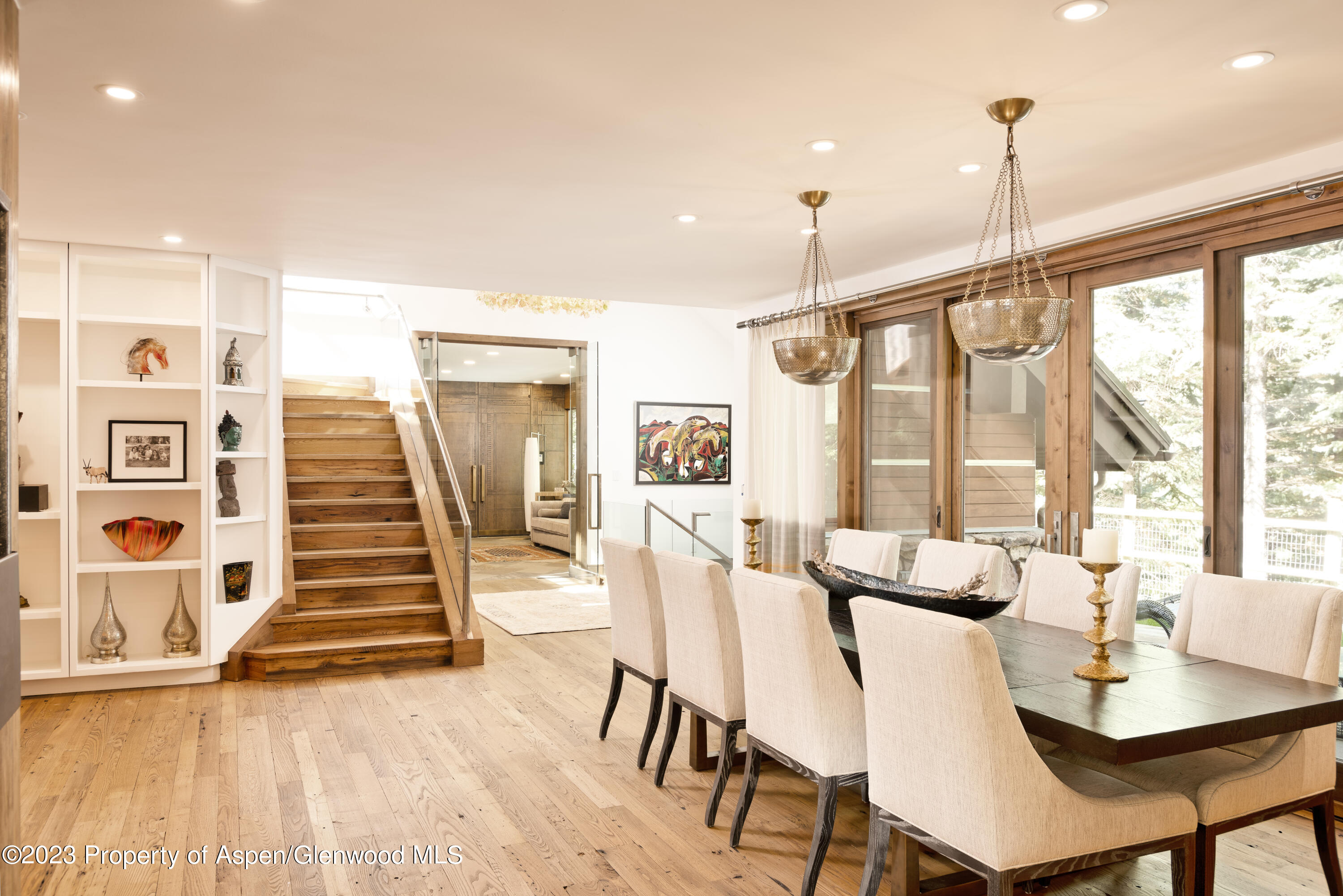 970 Powder Lane Aspen, CO 81611 - Photo 14 of 68 a dining room with wooden floor and large windows