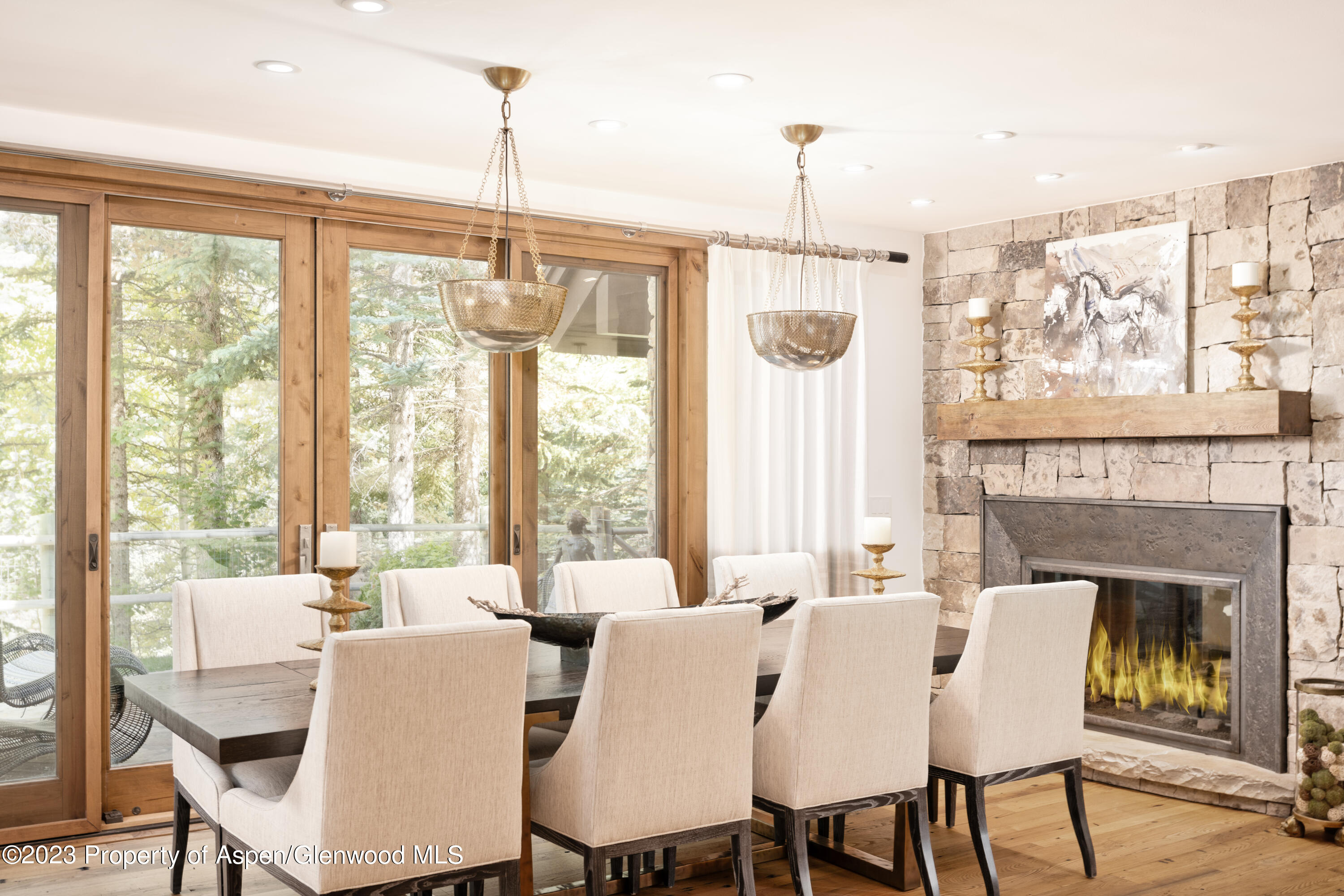 970 Powder Lane Aspen, CO 81611 - Photo 16 of 68 a view of a dining room with furniture large windows and wooden floor