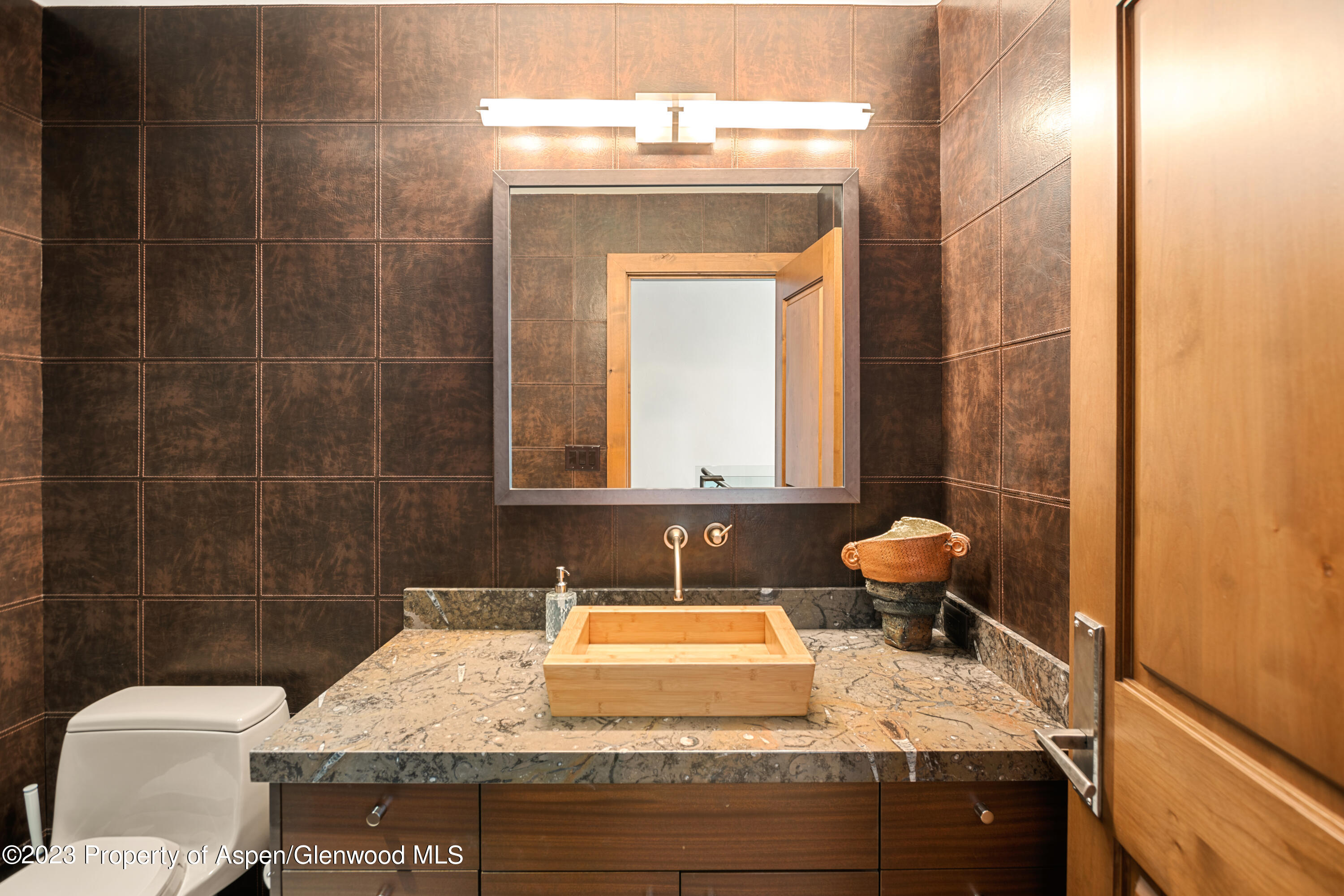 970 Powder Lane Aspen, CO 81611 - Photo 22 of 68 a bathroom with a granite countertop sink toilet and mirror