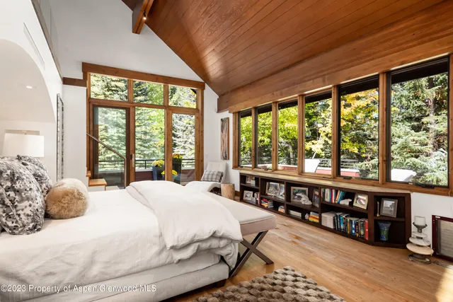 a bathroom with a granite countertop sink a toilet a mirror and shower