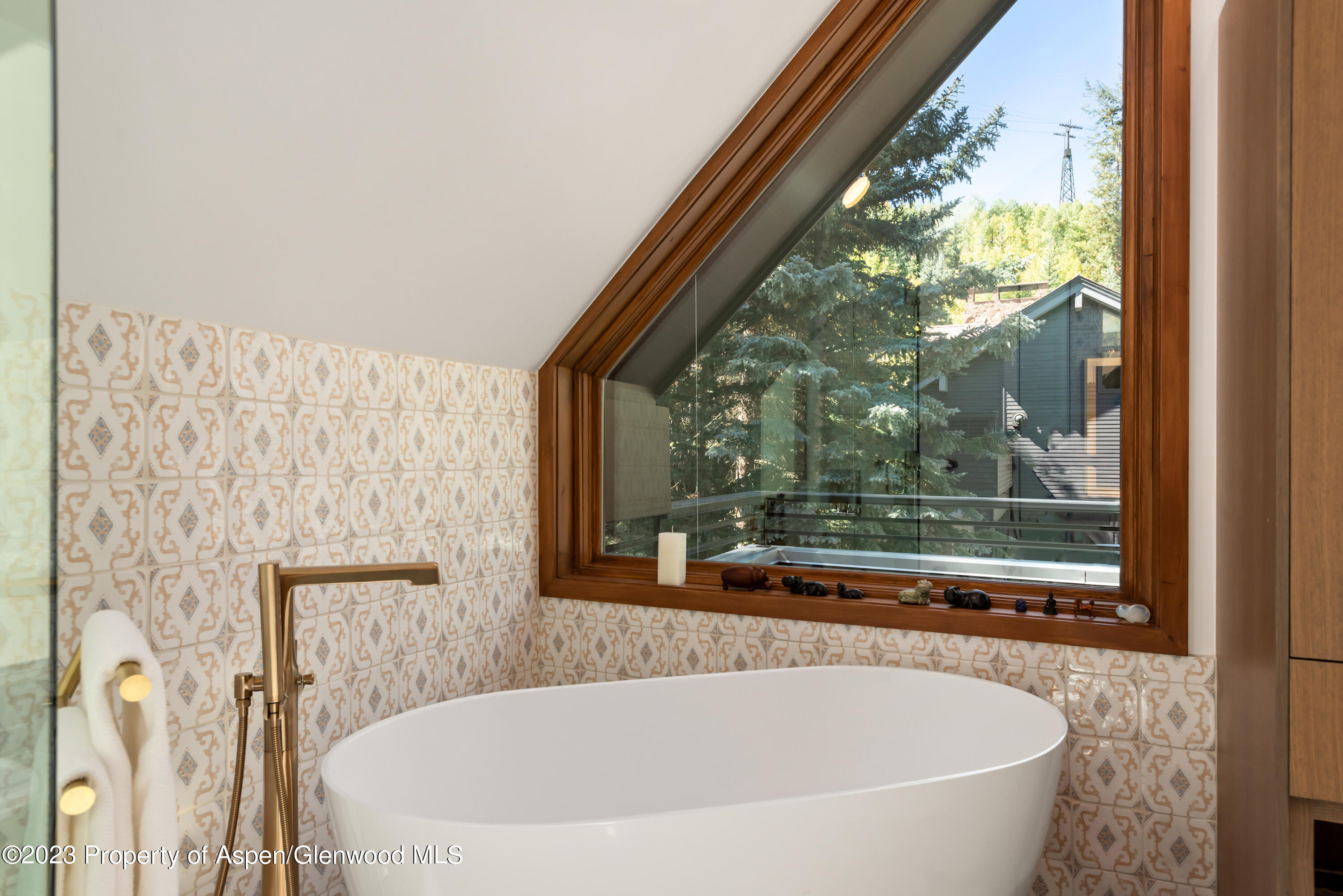 970 Powder Lane Aspen, CO 81611 - Photo 31 of 68 a white bath tub sitting in a bathroom next to a window