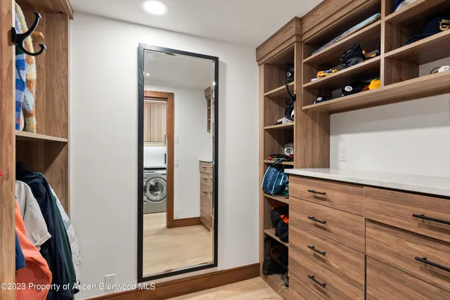 a bathroom with a sink a toilet a large mirror and shower