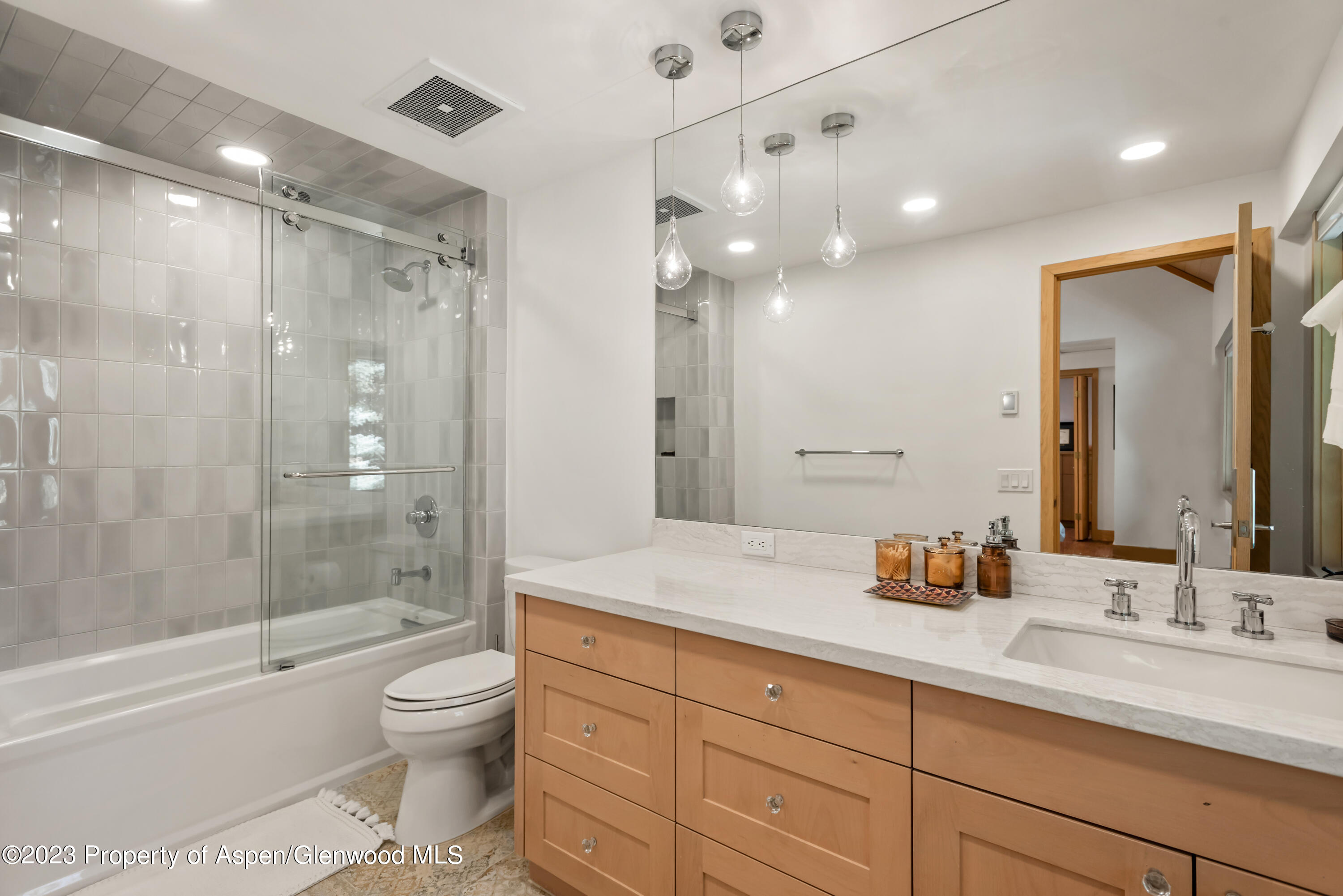970 Powder Lane Aspen, CO 81611 - Photo 44 of 68 a bathroom with a sink a toilet a large mirror and shower