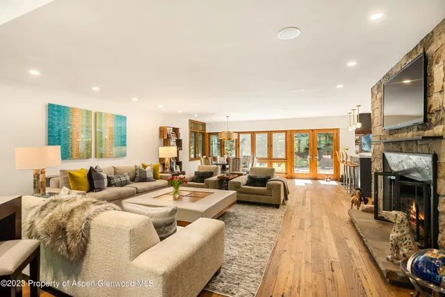 a kitchen with granite countertop a table chairs stove a refrigerator and cabinets