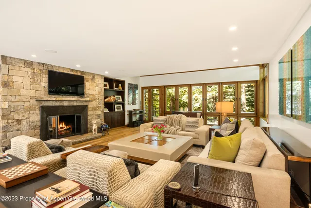 a living room with furniture and a fireplace