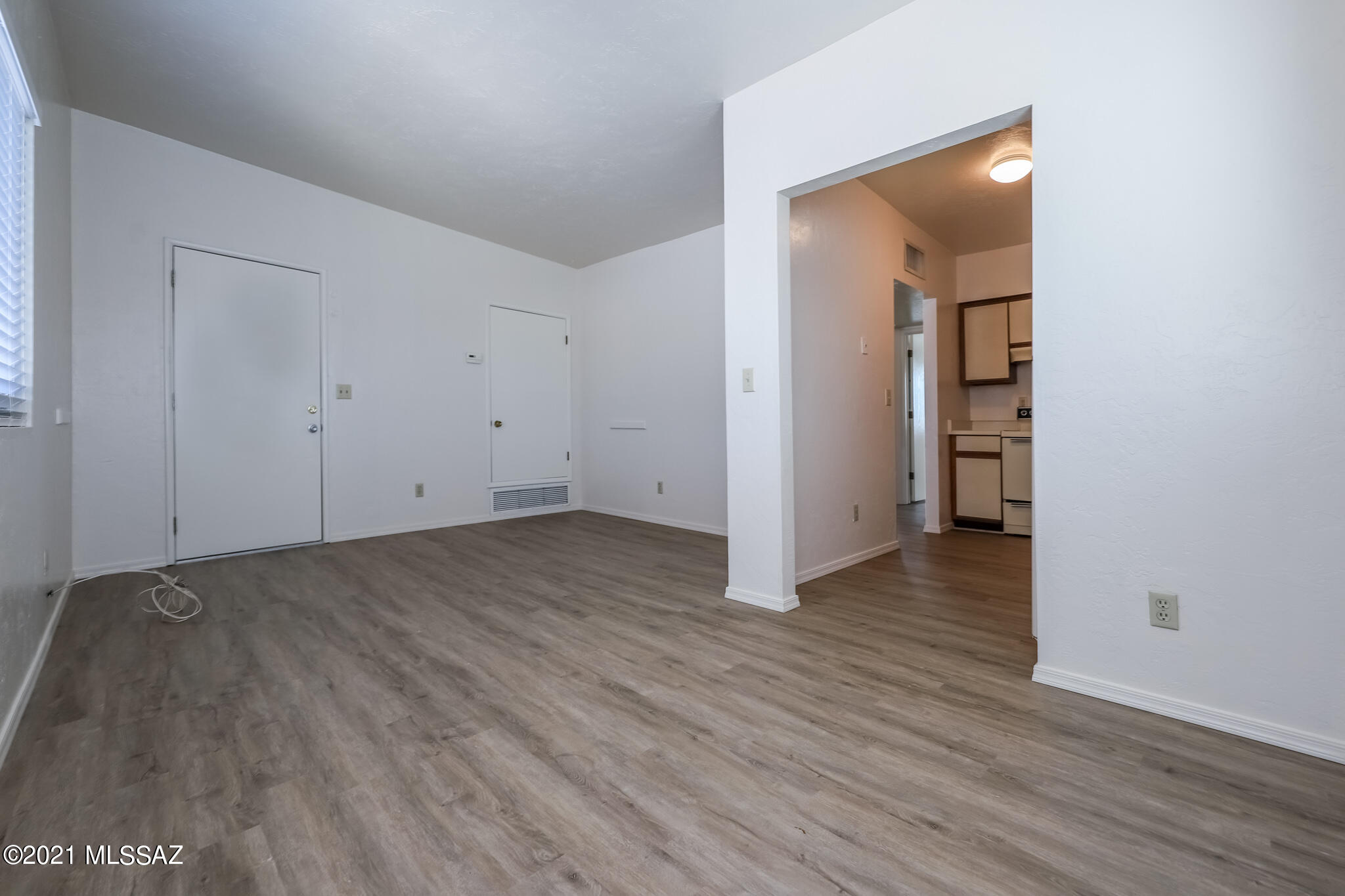 312 East 24th Street, Unit 4 Tucson, AZ 85713 - Photo 6 of 17 an empty room with wooden floor and closet