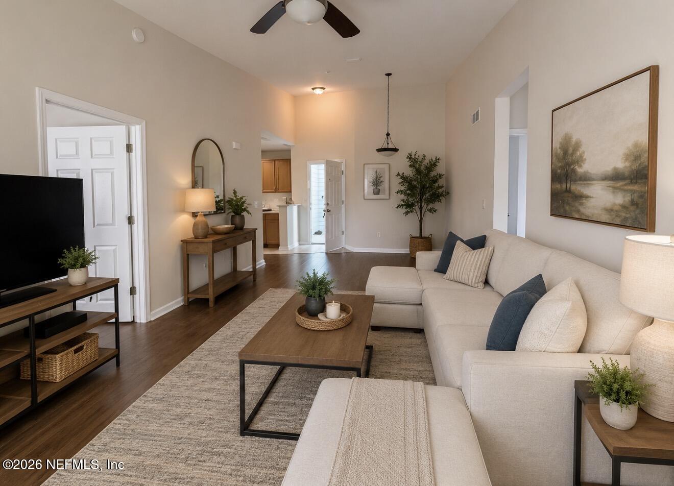 8218 Green Parrot Road, Unit 308 Jacksonville, FL 32256 - Photo 1 of 27 a living room with furniture a flat screen tv and kitchen view