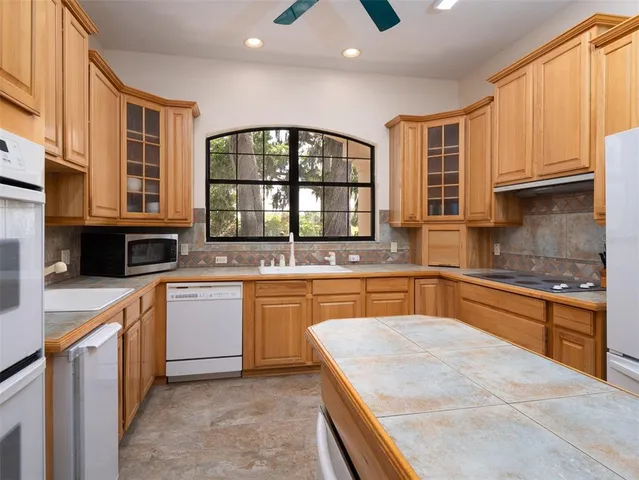 a kitchen with stainless steel appliances granite countertop a stove sink and cabinets