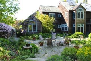 a view of a chair and table in backyard of the house