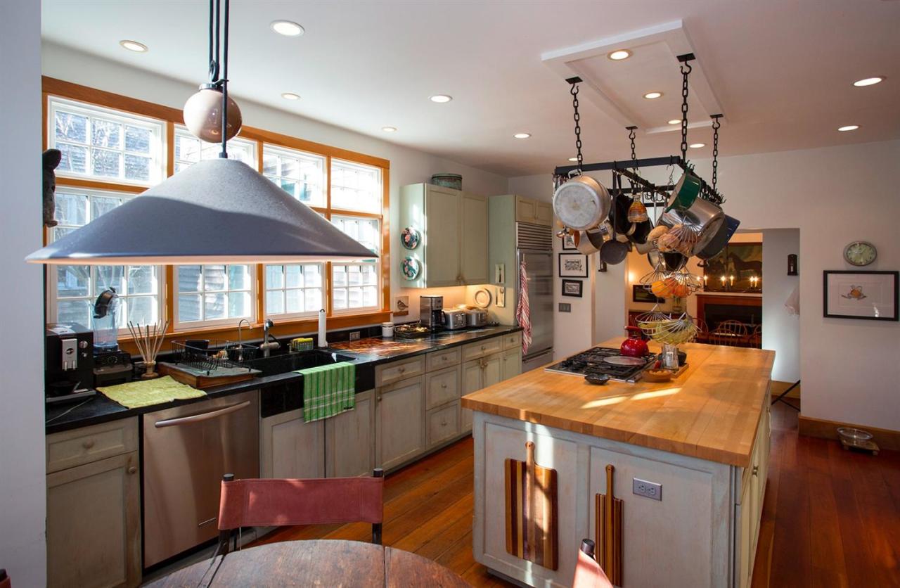 1 Nelson Drive Truro, MA 02666 - Photo 13 of 33 a kitchen with stainless steel appliances granite countertop a stove a sink a refrigerator and a wooden cabinets