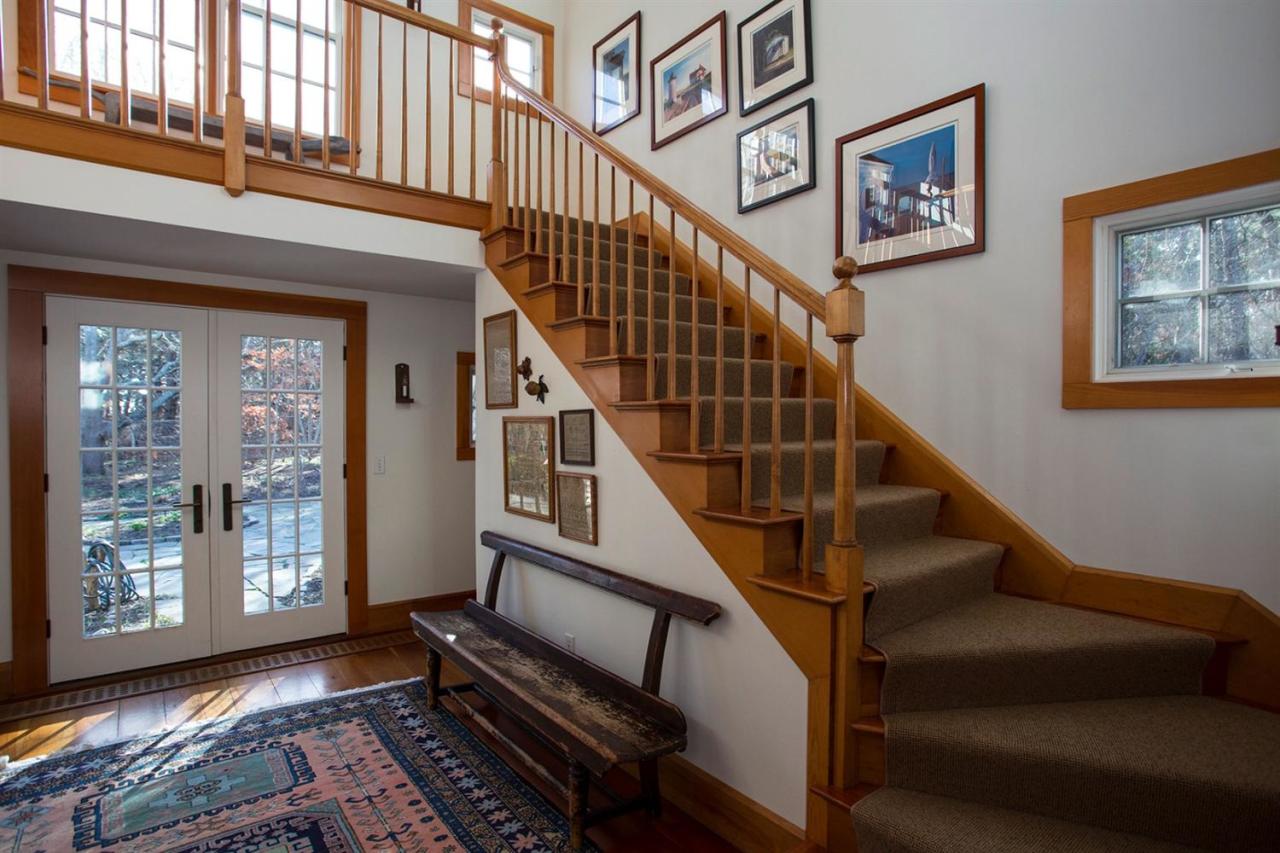 1 Nelson Drive Truro, MA 02666 - Photo 28 of 33 a view of staircase with lots of frames on wall and a window