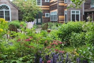 1 Nelson Drive Truro, MA 02666 - Photo 8 of 33 front view of a house with a yard and fountain in the back yard
