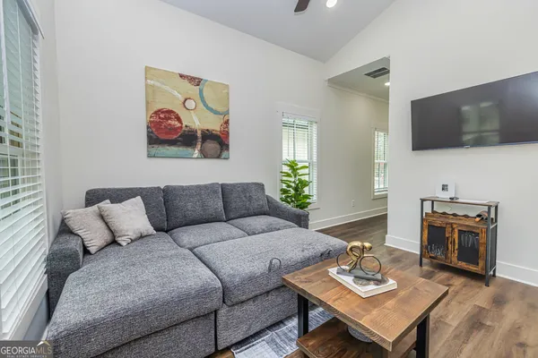 a living room with furniture and a flat screen tv