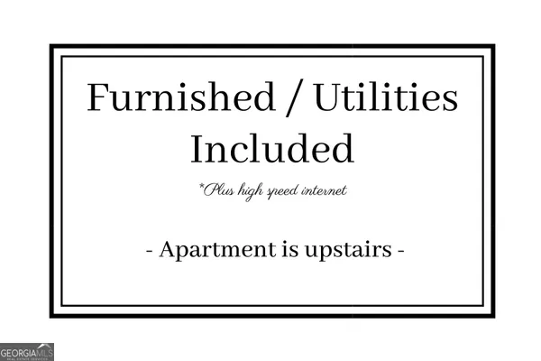 a view of a white house with large windows