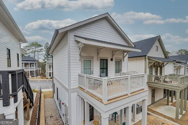 an aerial view of residential houses with outdoor space