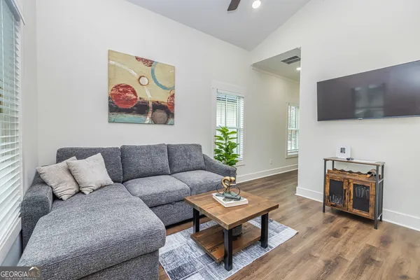 a living room with furniture and a flat screen tv