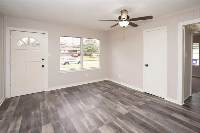 wooden floor in an empty room with a window