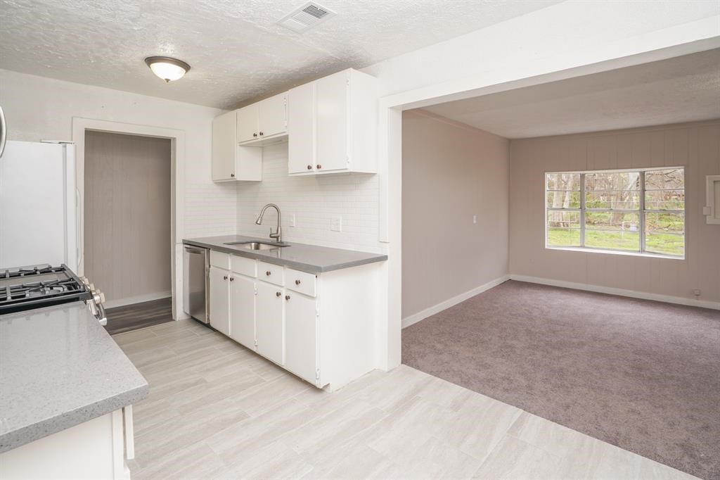 805 Horncastle Street Channelview, TX 77530 - Photo 4 of 12 a kitchen with a sink stove and cabinets