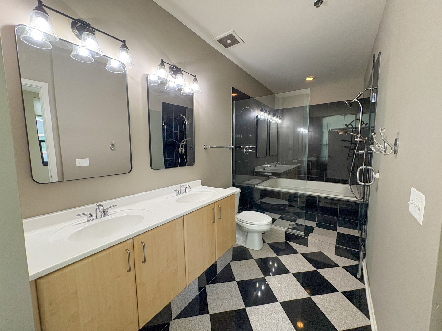 130 South Canal Street, Unit 9M Chicago, IL 60606 - Photo 14 of 14 a bathroom with a sink a toilet a mirror and shower