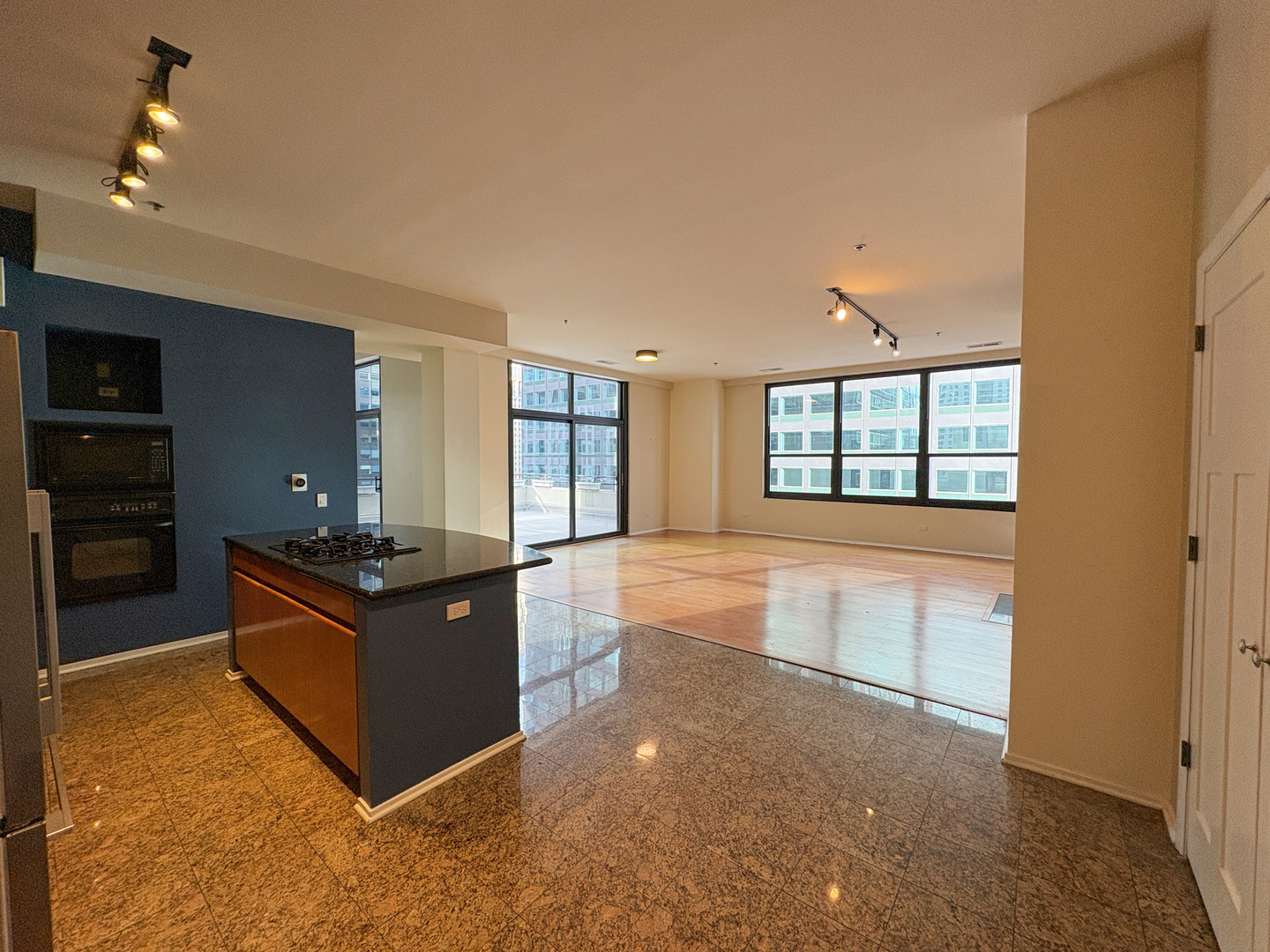 130 South Canal Street, Unit 9M Chicago, IL 60606 - Photo 3 of 14 a kitchen with stainless steel appliances granite countertop a stove and a refrigerator