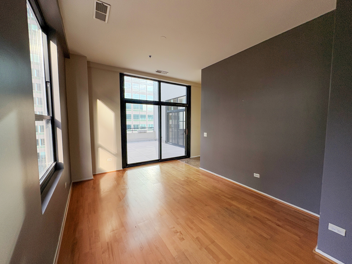 130 South Canal Street, Unit 9M Chicago, IL 60606 - Photo 8 of 14 a view of an empty room with wooden floor and a window