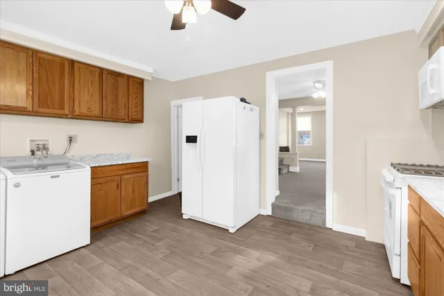 a view of a kitchen with a sink and a refrigerator