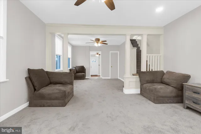 a living room with furniture and a large mirror