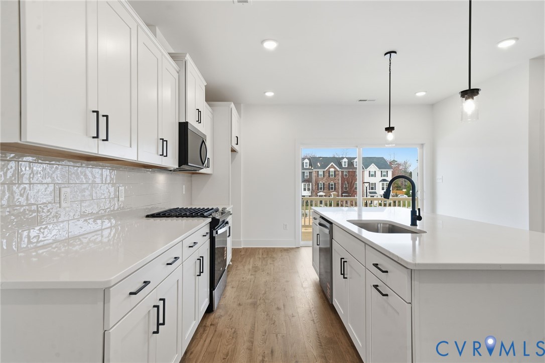 12049 Flowering Lavender Loop Henrico, VA 23233 - Photo 11 of 29 a kitchen with stainless steel appliances granite countertop a sink stove and cabinets