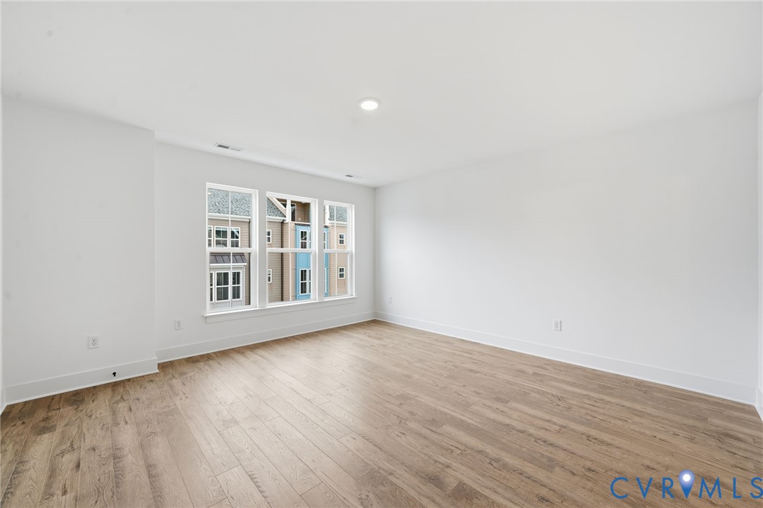 12049 Flowering Lavender Loop Henrico, VA 23233 - Photo 13 of 29 a view of an empty room with wooden floor and a window