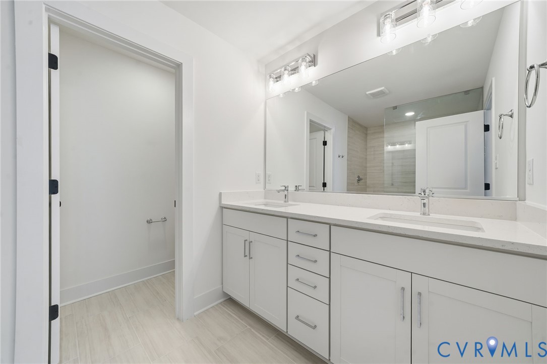 12049 Flowering Lavender Loop Henrico, VA 23233 - Photo 15 of 29 a bathroom with double sink and a mirror