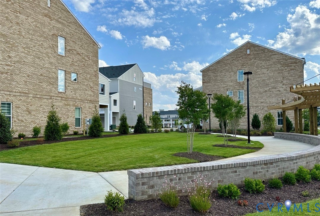 12049 Flowering Lavender Loop Henrico, VA 23233 - Photo 28 of 29 a front view of a house with a yard