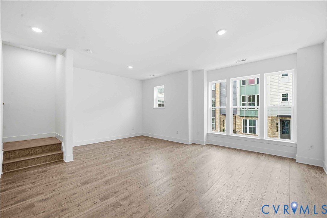 12049 Flowering Lavender Loop Henrico, VA 23233 - Photo 9 of 29 a view of an empty room with wooden floor and a window
