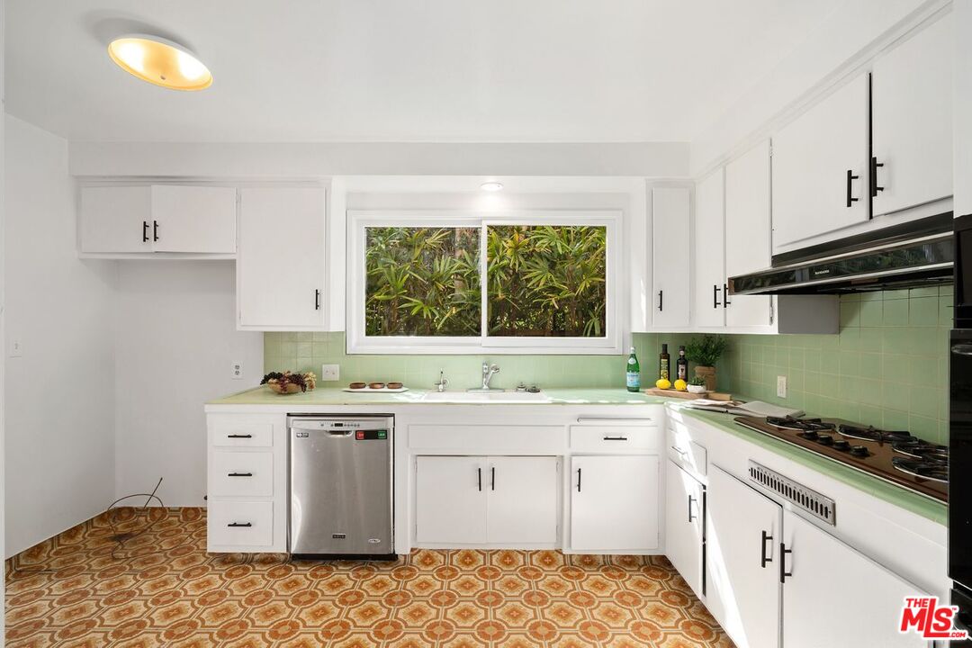 1012 Rose Avenue Venice, CA 90291 - Photo 11 of 27 a kitchen with a sink stove and cabinets