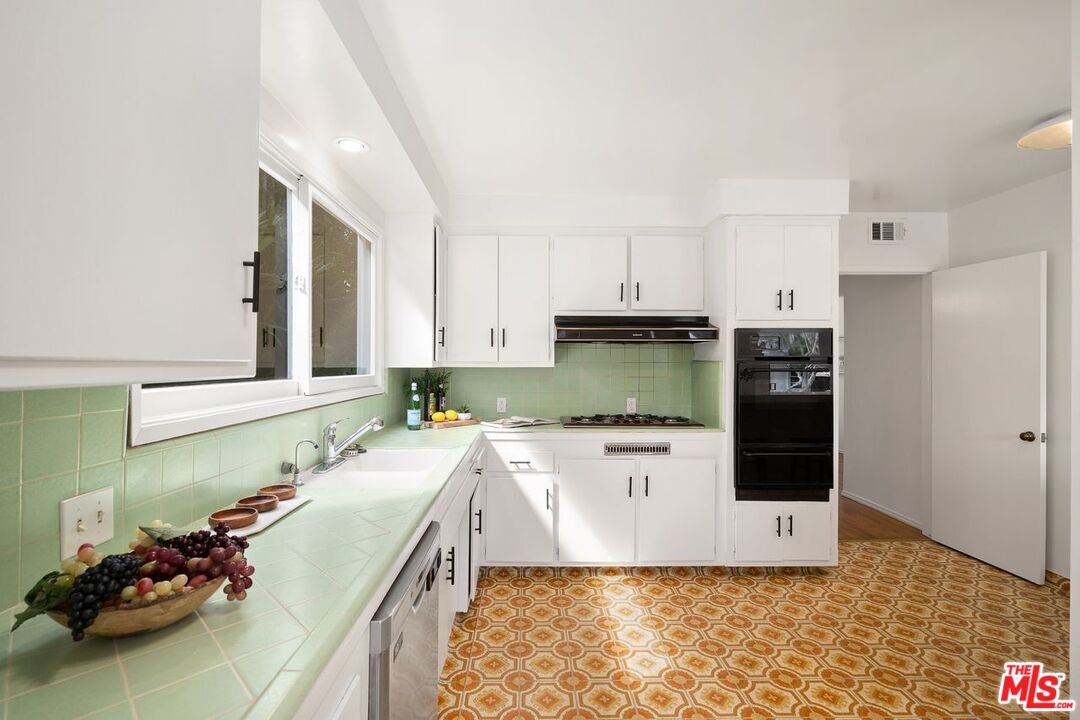 1012 Rose Avenue Venice, CA 90291 - Photo 12 of 27 a kitchen with a sink stove and cabinets