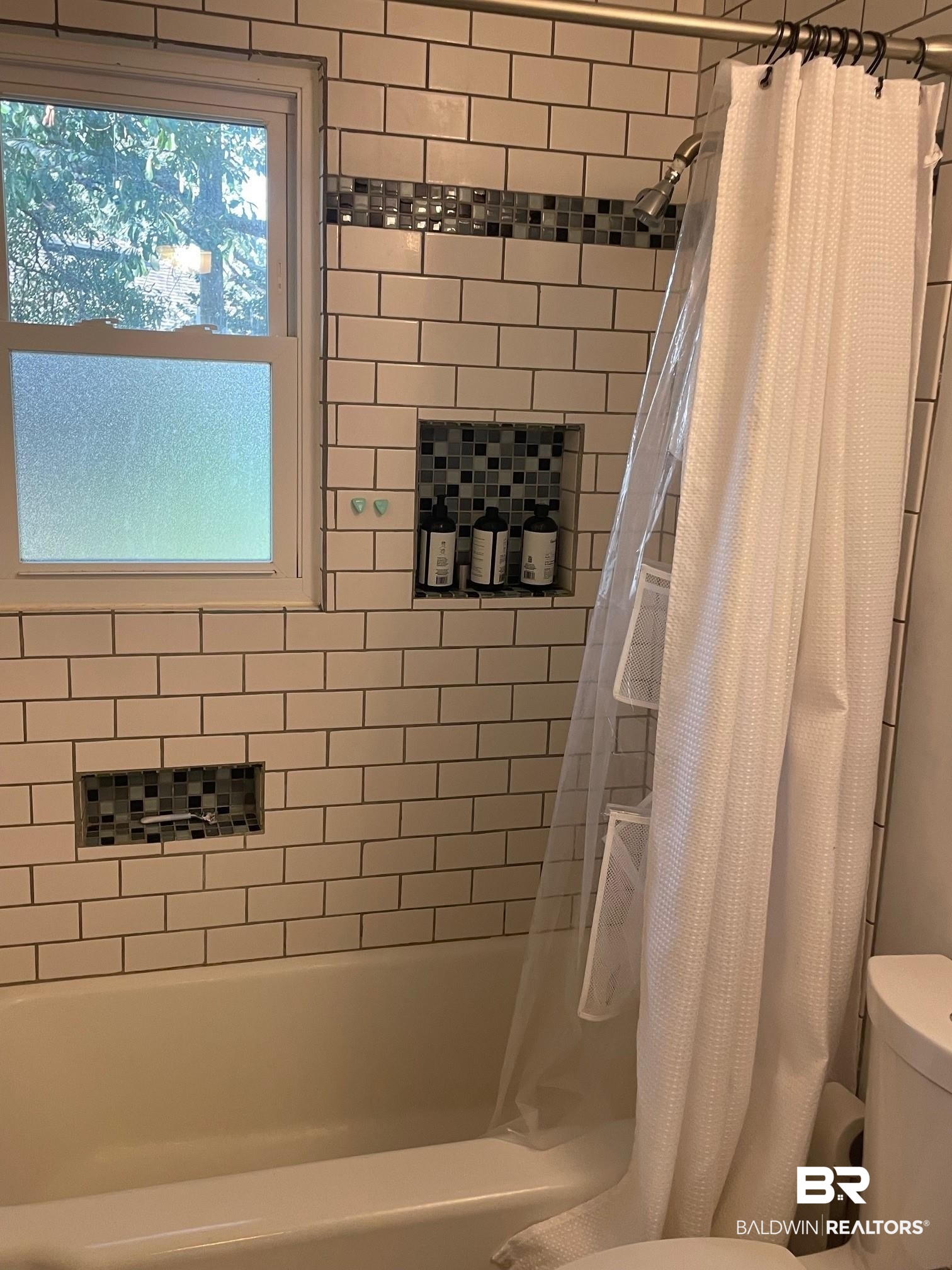 20 Lancaster Road Mobile, AL 36608 - Photo 10 of 13 Bathroom featuring toilet and shower / bathtub combination with curtain