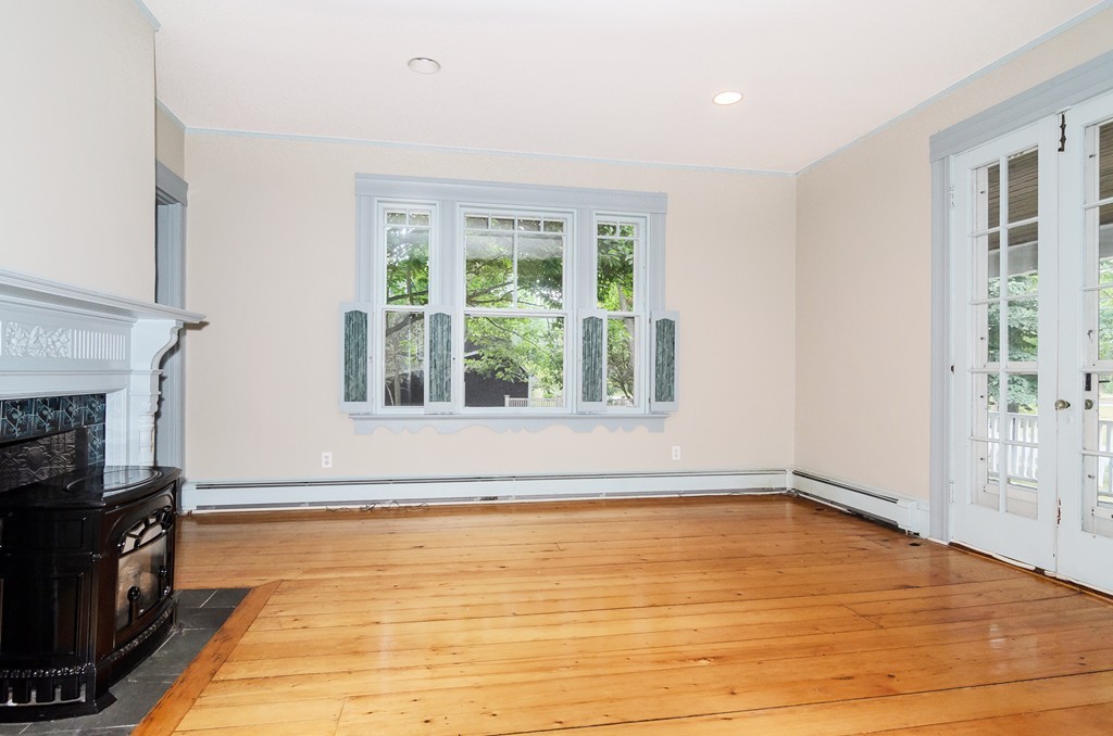 32 Dover Road Wellesley, MA 02482 - Photo 3 of 16 a view of empty room with kitchen and fireplace