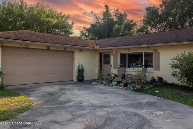 a backyard of a house with yard and outdoor seating