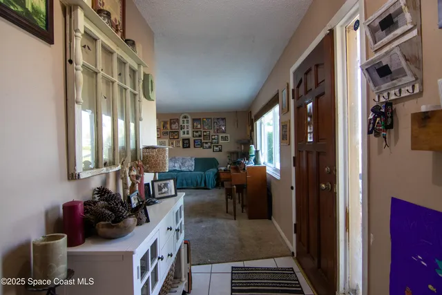 a bedroom with furniture and a large window