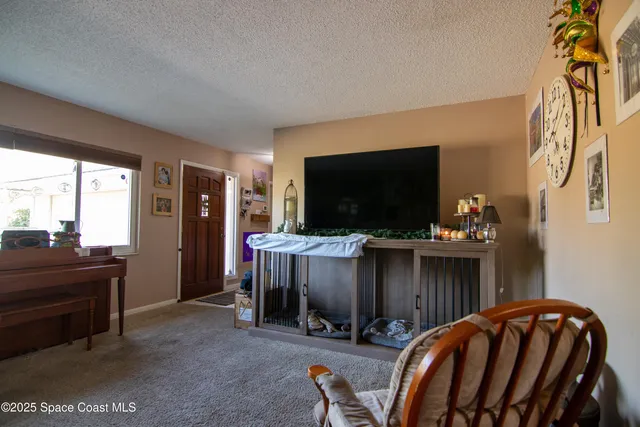 a view of a livingroom with furniture and a window