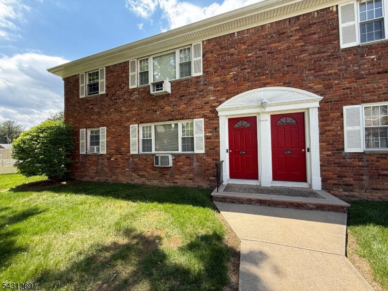 1241 Valley Road, Unit 1241 Wayne, NJ 07470 - Photo 8 of 12 a front view of a house with a yard