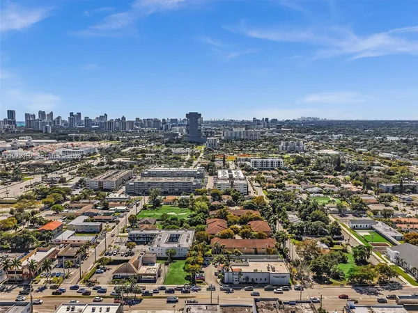 a green field with lots of trees