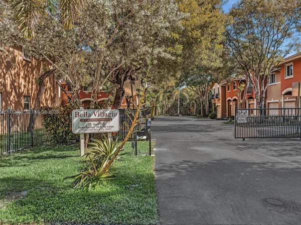 a view of staircase with lots of frames on wall and windows